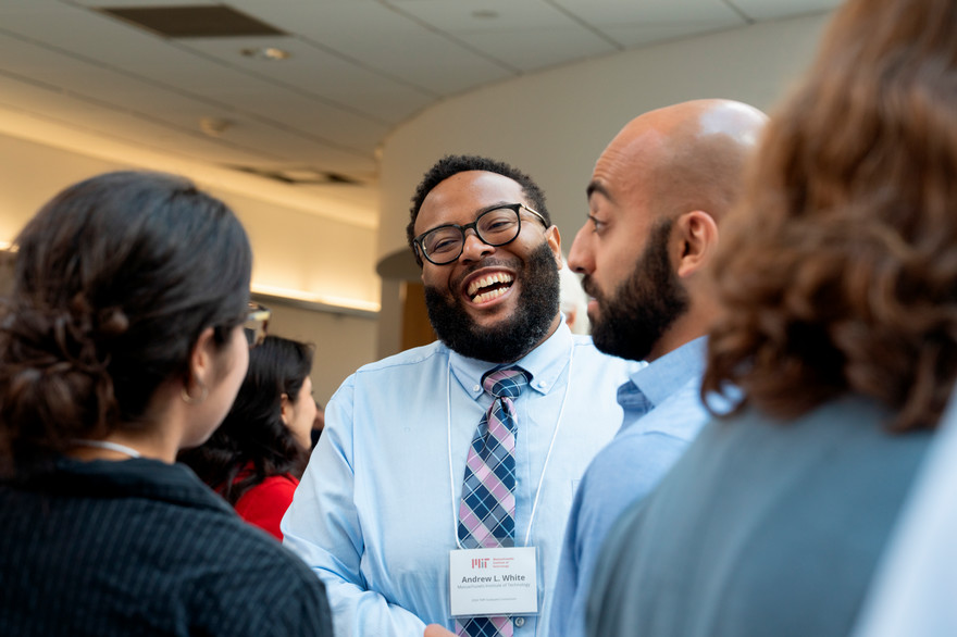 man laughing with colleagues
