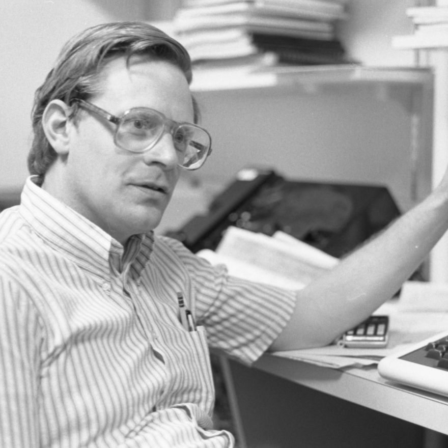 black and white photo of granger in front of an old computer