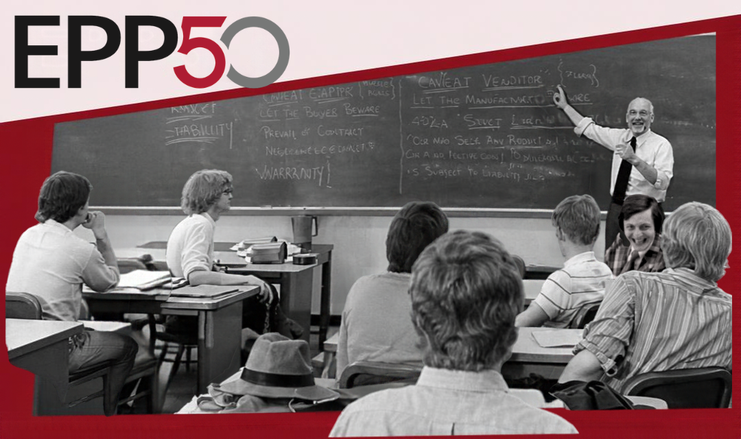 archival image of a male teacher teaching a class of students about product liability